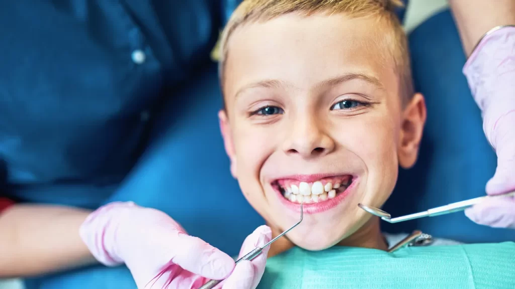 Boy smiling during tooth examination