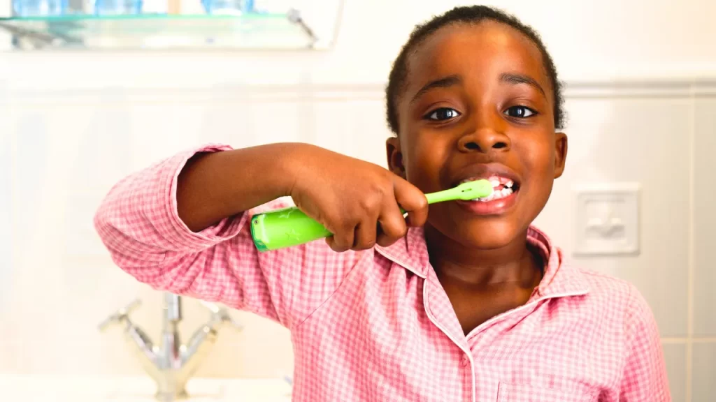 little girl brushing her teeth