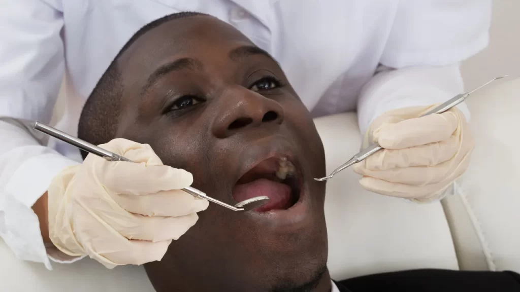 black man getting an oral examination