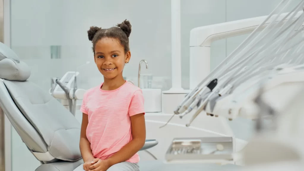 Girl sitting on a chair at the dentist